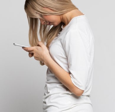 Caucasian female using mobile phone with scoliosis, side view. Rachiocampsis, kyphosis curvature of the spine, Incorrect posture, scoliosis, orthopedics concept
